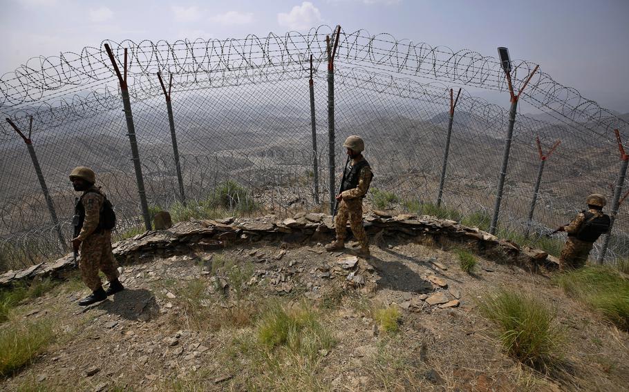 Pakistan Army troops patrol along the fence on the Pakistan Afghanistan border at Big Ben hilltop post in Khyber district, Pakistan, Aug. 3, 2021. 