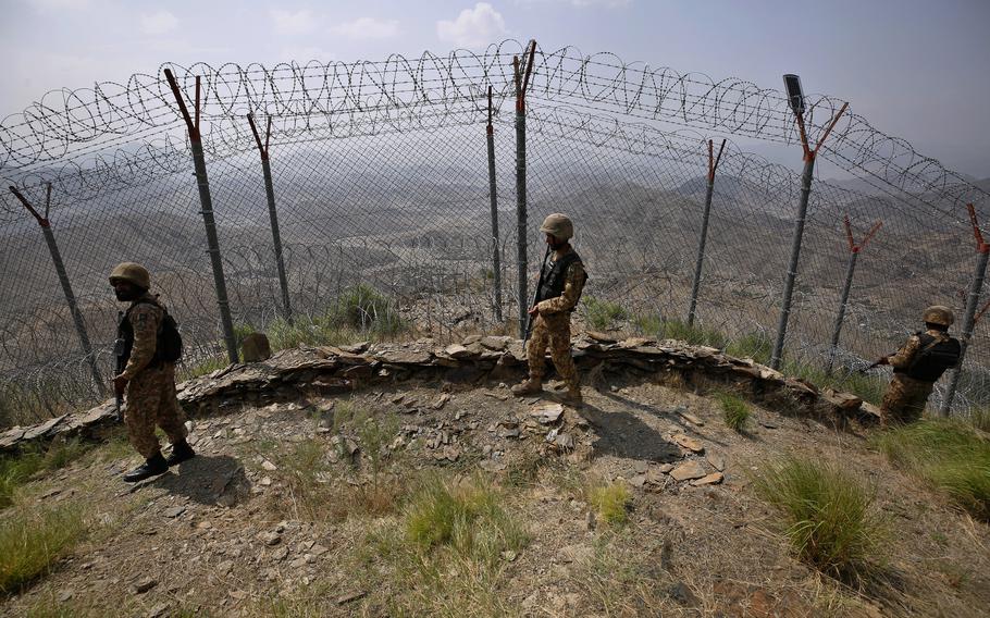 Pakistan Army troops patrol along the fence on the Pakistan Afghanistan border at Big Ben hilltop post in Khyber district, Pakistan, Aug. 3, 2021.
