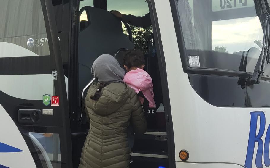 An Afghan woman and her child prepare to leave Fort McCoy, Wis., Oct. 11, 2021, after finishing processing procedures at the base. 