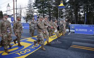 Members of the United States military cross the starting line as they participate in the Boston Marathon, Monday, April 15, 2024, in Hopkinton, Mass. (AP Photo/Mary Schwalm)