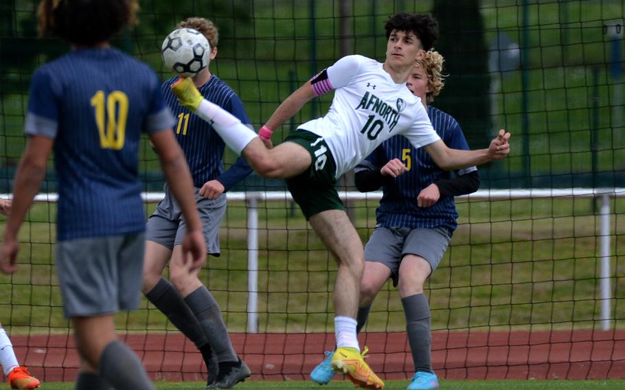 AFNORTH’s Christan Barone makes an acrobatic pass to a teammate as Ansbach’s Sam Hanson defends at right. Ansbach beat AFNORTH 5-3 in a Division III semifinal at the DODEA-Europe soccer championships in Kaiserslautern, Germany, May 17, 2023, and will face Sigonella in Thursday’s final.