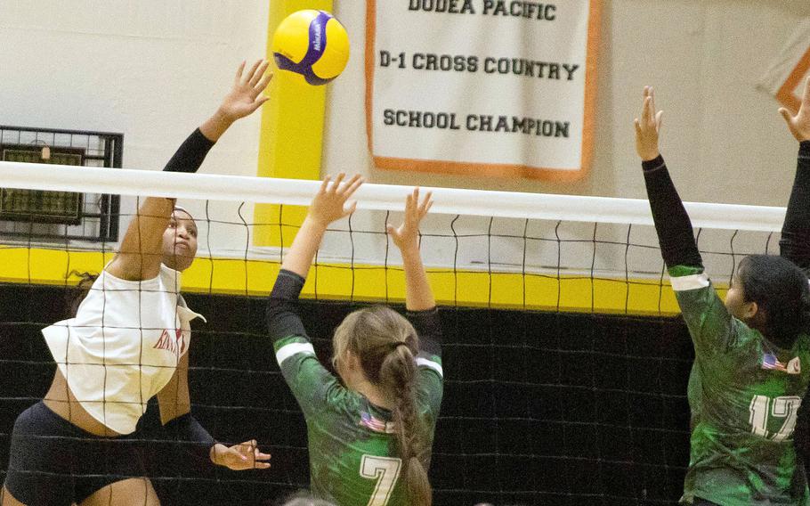 Nile C. Kinnick's Ja'lilah Brice spikes against Kubasaki's Isabella Garza and Ayeli Rocha.