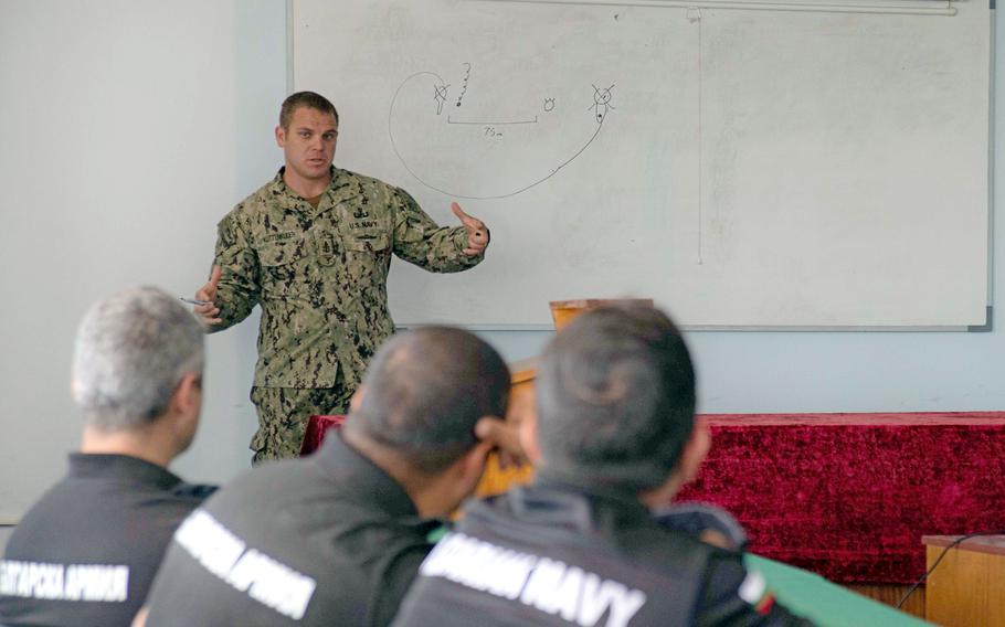 Senior Chief Petty Officer Matthew Kuttenkuler, assigned to Explosive Ordnance Disposal Mobile Unit 12, delivers a brief on U.S. floating mine response procedures to Bulgarian sailors during exercise Breeze 2022, July 14, 2022, in Varna, Bulgaria.