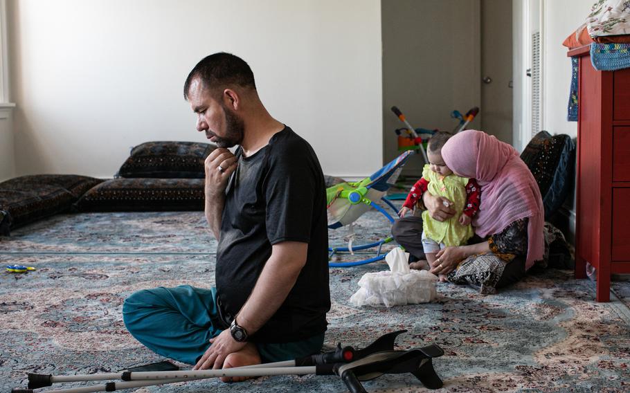 Tabesh with his wife and baby daughter, Moqadas, at his home.