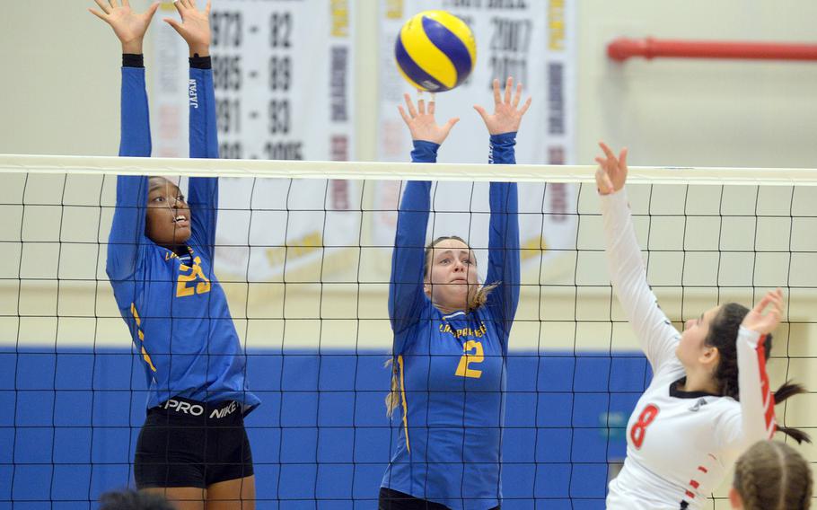 E.J. King's Sarah Goleman tries to get a shot through the double block of Yokota's Trinity Stegall and Malia Hutchins during Saturday's DODEA-Japan volleyball match. The Cobras won in straight sets to sweep the two weekend matches.