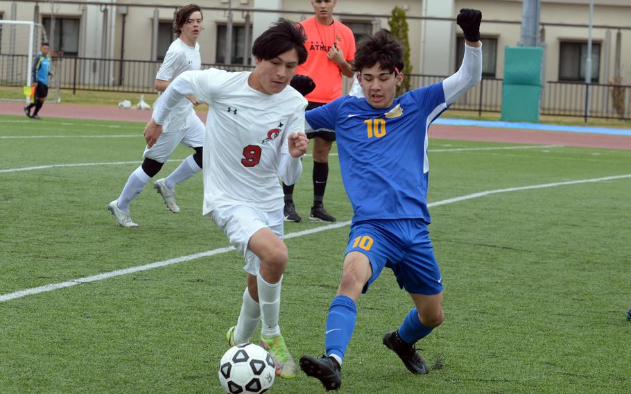 Yokota's Kai Patton boots the ball past E.J. King's Chris Garcia during Saturday's DODEA-Japan boys soccer match. The Panthers won 4-0.