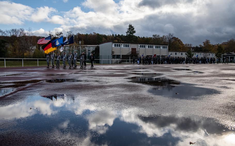 A color guard comprised of students from Kaiserslautern and Ramstein High Schools leads a silent lap around the Kaiserslautern High School track on Friday, Nov. 10, 2023, to honor U.S. veterans who died by suicide. 