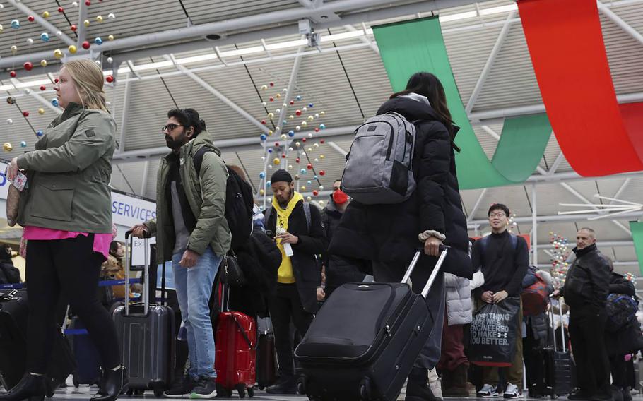 Holiday travelers move through check-in and security process in Terminal 1 at Chicago O’Hare International Airport on Dec. 21, 2022. 