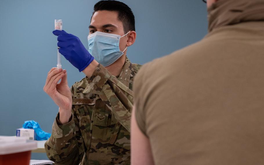 Airman 1st Class Thadyn DuPont, an aerospace medical technician with the 137th Special Operations Medical Group, prepares to administer a coronavirus vaccine for an Oklahoma Army National Guard soldier at the Armed Forces Reserve Center in Norman, Okla., on Jan. 15, 2021. 