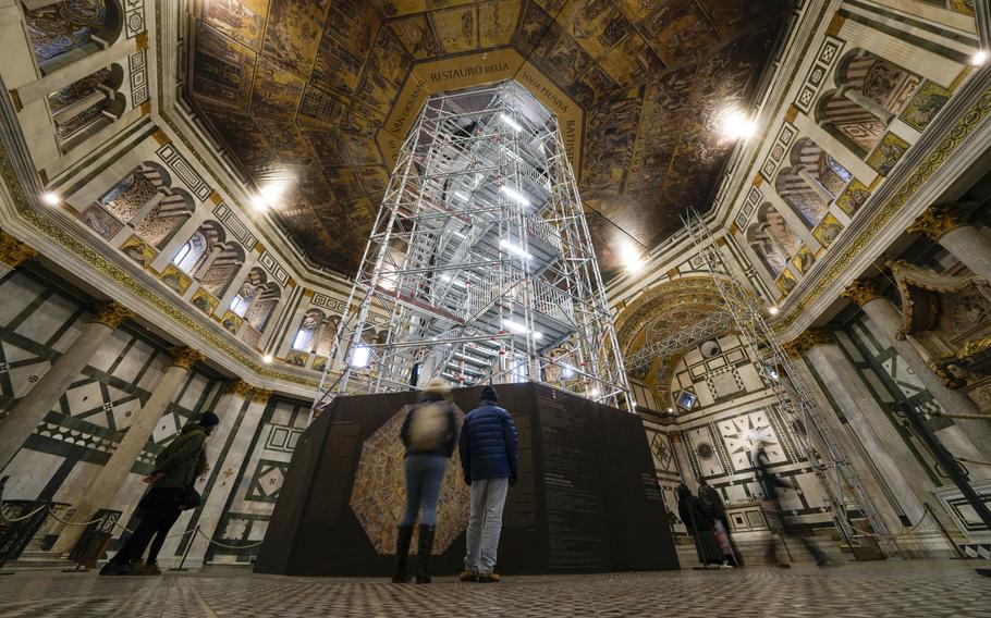 Visitors admire the Baptistery of San Giovanni on Feb. 7. The restoration work on the Baptistery’s dome will be done from an innovative scaffolding shaped like a giant mushroom that will stand for the next six years in the center of the church, and that will be open to visitors allowing them for the first and perhaps only time, to come face to face with more than 1,000 square meters of precious mosaics covering the dome.
