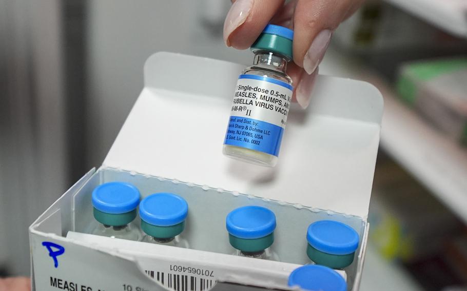 A vial is pulled from a box.