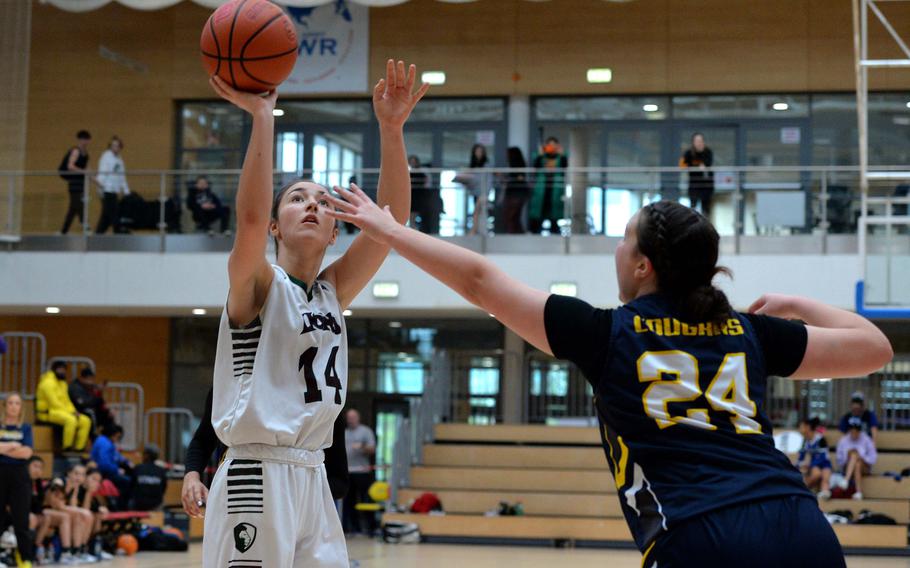 AFNORTH’s Maggie Masse shoots over Ansbach’s Kennedy Lange in the girls Division III final at the DODEA-Europe basketball championships in Wiesbaden, Germany, Feb. 17, 2024. AFNORTH took the division title with a 34-23 victory.