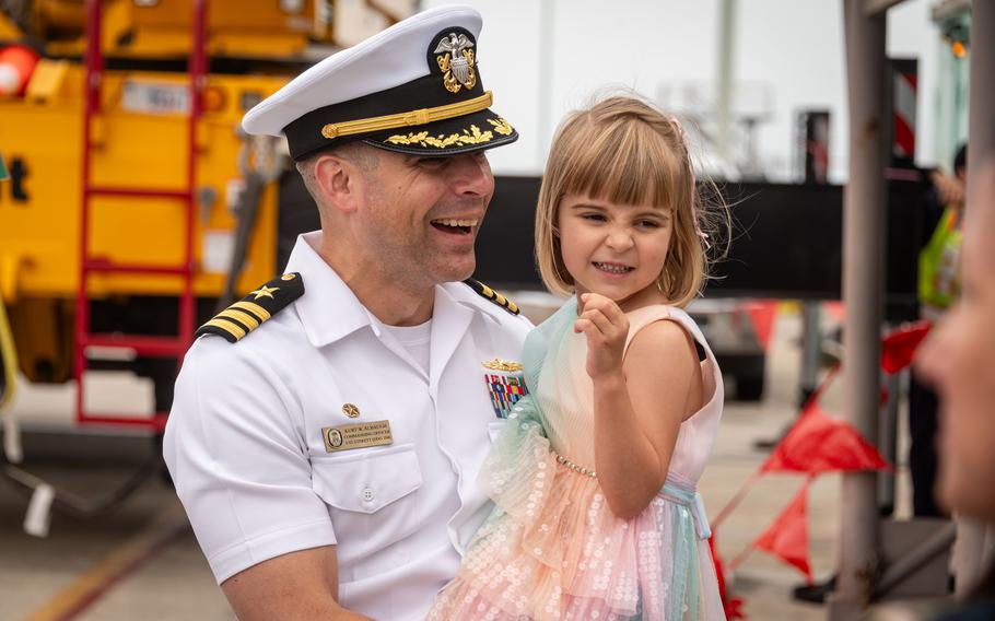 Albaugh smiles and holds his daugther.