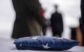 A folded American flag, flown aboard the amphibious assault ship USS Boxer (LHD 4), lays on a table for a burial at sea ceremony in the Pacific Ocean July 17, 2024. The ceremony was held for retired Navy Senior Chief Master-at-Arms Kevin Buckley, father of Marine Corps Gunnery Sgt. Gregory Buckley, the communications operations chief assigned to the 15th MEU, and a native of Carthage, New York. Elements of the 15th MEU are currently embarked aboard the Boxer Amphibious Ready Group conducting routine operations in U.S. 3rd Fleet. (U.S. Marine Corps photo by Cpl. Amelia Kang)