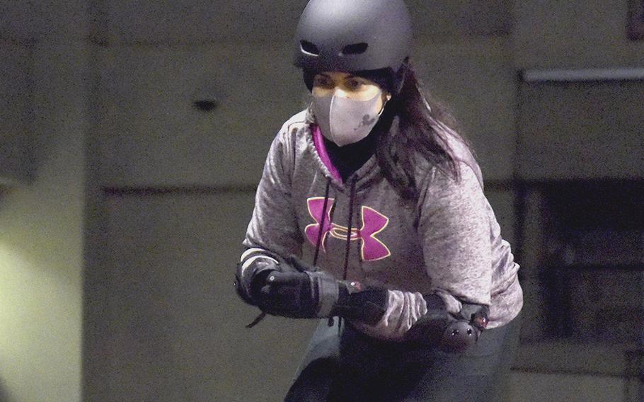 Mimi Torres, a Fuji Flatliner, practices lifting one leg while skating during roller derby practice at Yokota Air Base, Japan, on Feb. 28, 2022. 