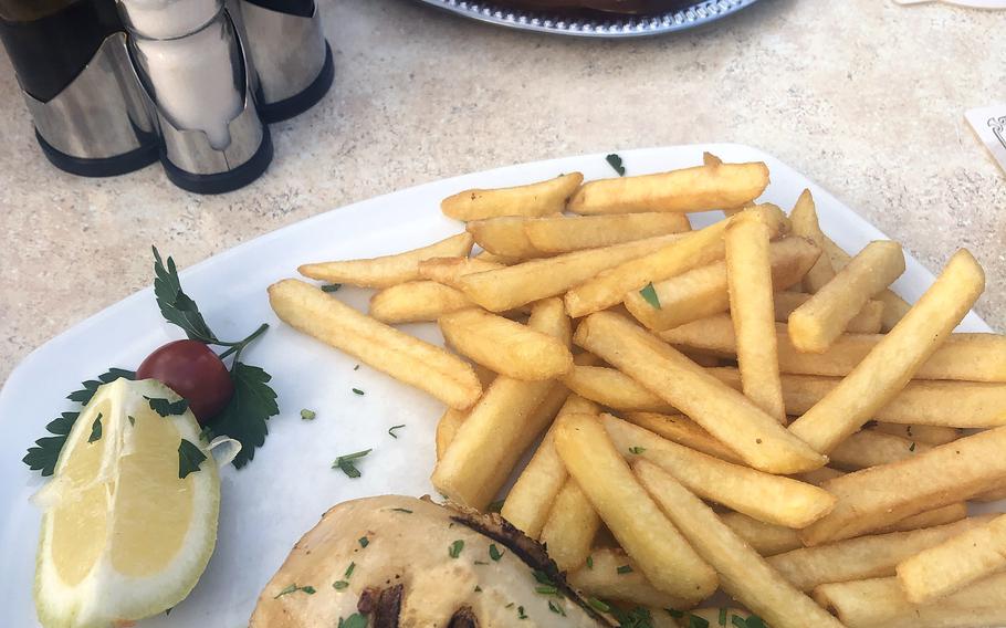 Stuffed grilled calamari with fries and baked sheep’s cheese in the background, as served at Piazza in Griesheim, Germany. The popular locale offers a cornucopia of dishes from a variety of cuisines. 