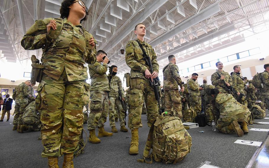 Fort Stewart soldiers with the 3rd Battalion, 69th Armored Regiment of the 3rd Infantry Division’s 1st Armored Brigade Combat Team prepare to board a flight bound for Germany out of Hunter Army Airfield, Ga., on Tuesday, March 2, 2022. 
