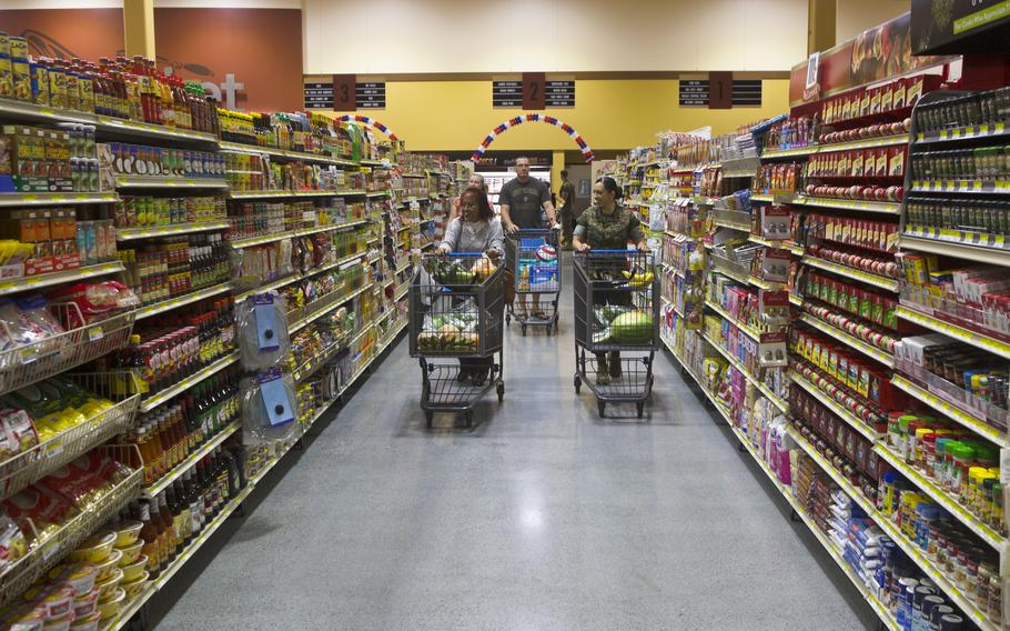 U.S. military service members and civilian personnel attend the grand opening ceremony of the new commissary on Marine Corps Air Station Iwakuni, Japan, June 21, 2016.