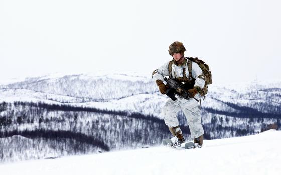 U.S. Army Spc. Hunter Klemens of the 501st Parachute Infantry Regiment snowshoes over a lake March 18, 2024, after a jump near Bardufoss, Norway.