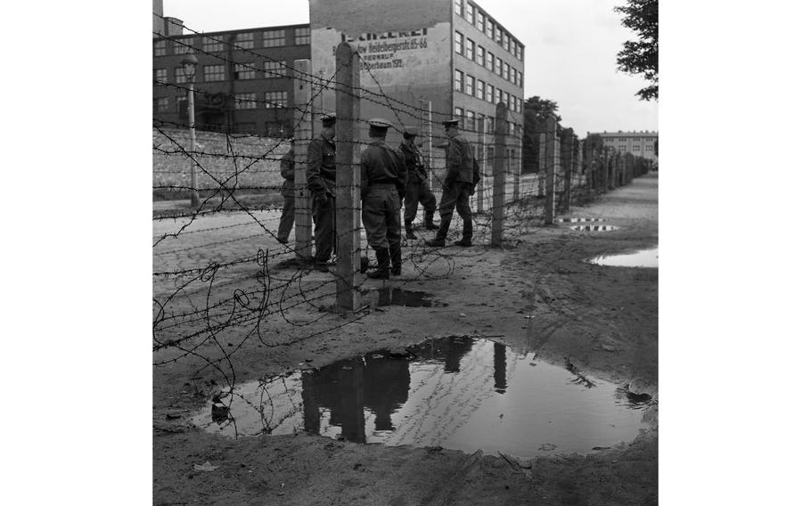 Barbed wire plays an important part in the East Zone Communists’ scheme of things, as demonstrated by those Vops who are laying a strand at the border in Berlin.