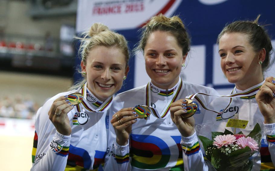 The Australian team, from left, Melissa Hoskins, Amy Cure, Ashlee Ankudinoff and Annette Emonodson, unseen, pose with their gold medal celebrates during the Women’s Team Pursuit race medal ceremony at the Track Cycling World Championships in Saint-Quentin-en-Yvelines, outside Paris, France, on Feb. 19, 2015.