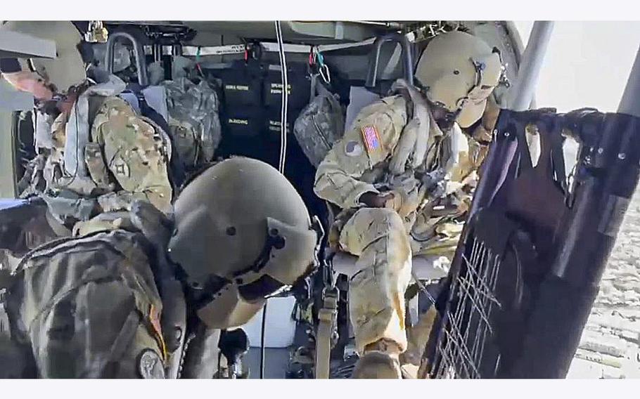 Soldiers from the Florida Army National Guard’s 1-111th Aviation Regiment ride in a helicopter en-route to Sanibel Island, Florida on Sept. 30, 2022, as they assist with medical evacuations in addition to search and rescue operations in the wake of Hurricane Ian.