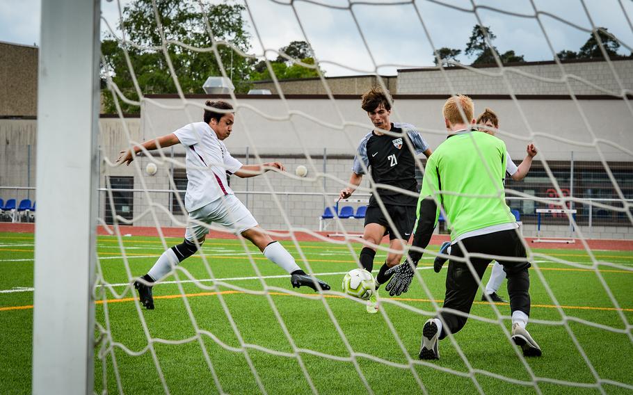 Stuttgart Panther Mateo Sandoval navigates past the Lakenheath Lancers defense to challenge goalie Aiden Stamp during the DODEA-Europe soccer championships at Ramstein Air Base, Germany, Monday, May 16, 2022. Stamp and his defense had a tough time against a solid Stuttgart offense, which sank seven goals against Lakenheath.