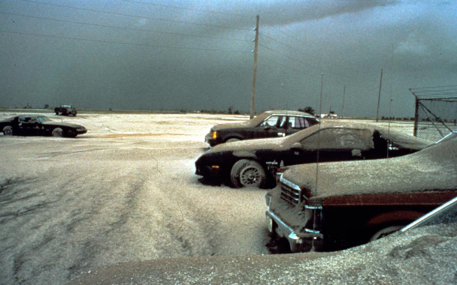 Ash covers the ground and cars at Clark Air Base, Philippines, a day after the eruption of Mount Pinatubo on June 15, 1991. 