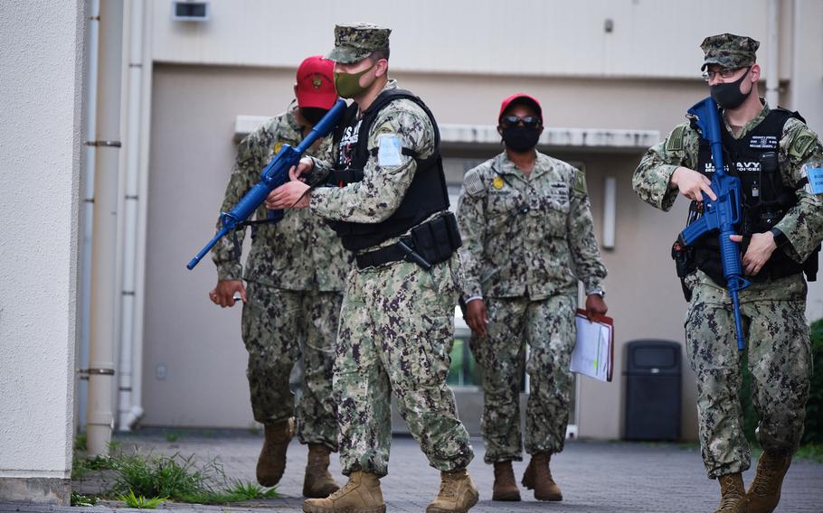 Petty Officer 1st Class James Eggers and Petty Officer 2nd Class Andres Gonzalez wield rubber M4 carbines during an active-stabber drill at the exchange at Yokosuka Naval Base, Japan, July 20, 2021. The action was part of the Citadel Pacific exercise. 