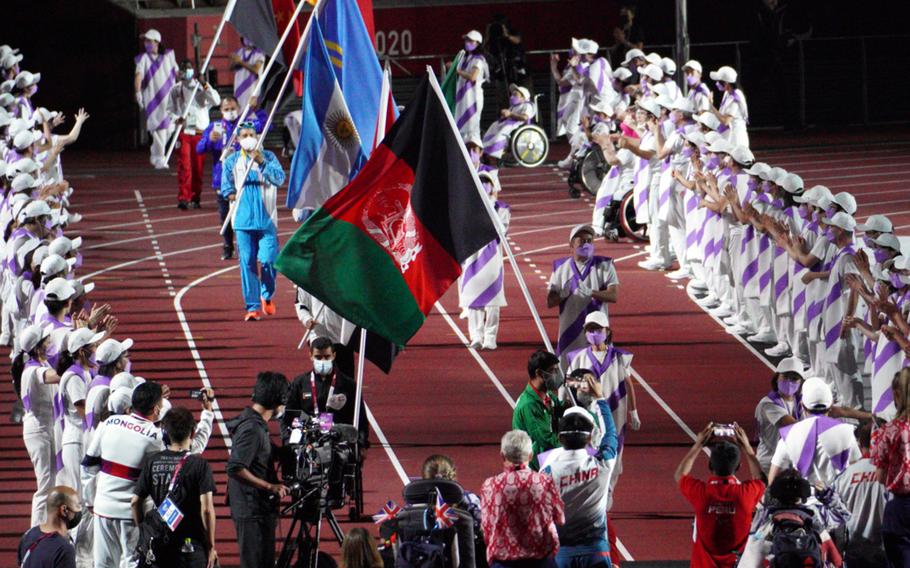 Athletes carry the Afghanistan flag during closing ceremonies for the Tokyo Paralympics at National Stadium, Sunday, Sept. 5, 2021. 