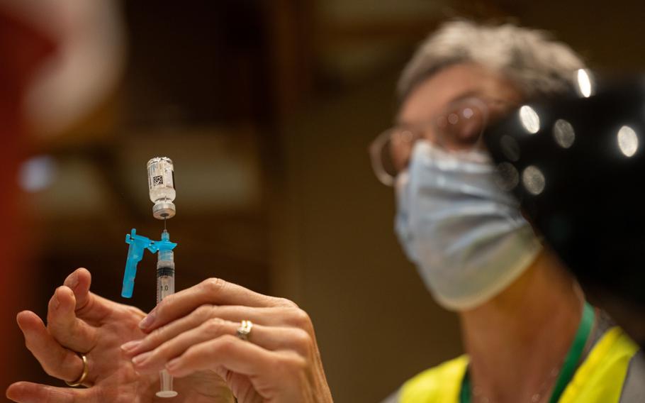 A healthcare worker fills a syringe with a dose of the Johnson & Johnson COVID-19 vaccine at a vaccination popup location inside the Louisville Zoo in Louisville, Ky., on Aug. 6, 2021.