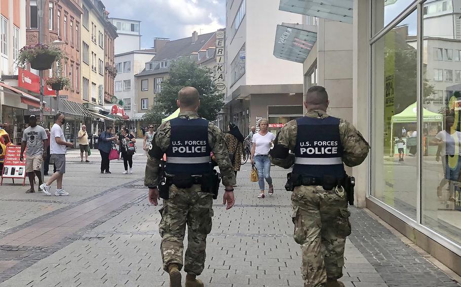 Two U.S. military policemen walk through the pedestrian zone in Kaiserslautern, Germany, on July 26, 2021. German officials have started tightening coronavirus restrictions in the city as infection rates rose.