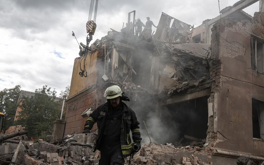 Firefighters work at a heavily damaged residential building as they look for victims after a Russian attack on Sept. 8, 2022, in the eastern city of Sloviansk, Ukraine.