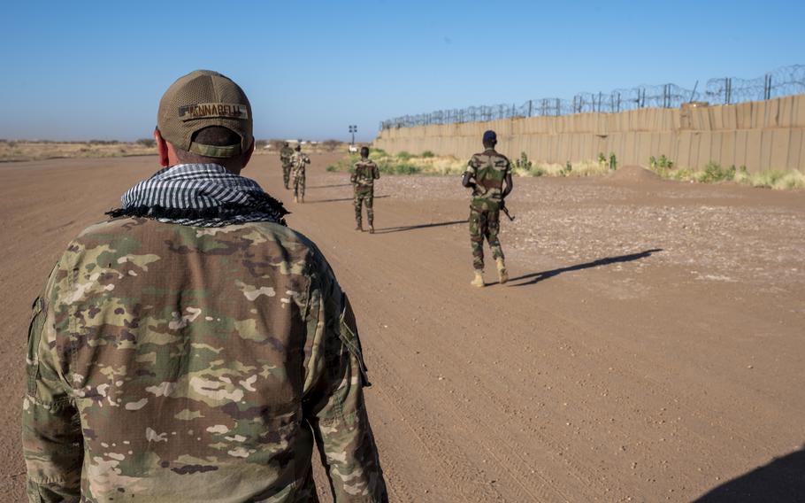 Air Force Tech. Sgt. Daniel Iannarelli observes ground maneuvers by members of Niger’s armed forces Nov. 16, 2022, during a field training exercise at Base 201 in Niger. The U.S. has paused some security cooperation efforts in Niger and isn’t conducting military training at the moment, following an attempted coup in the African nation.