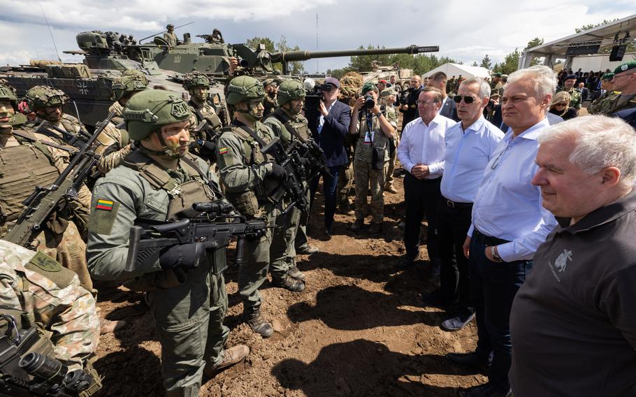 Defense Minister of Lithuania Arvydas Anusauskas, Lithuania President Gitanas Nauseda, NATO Secretary-General Jens Stoltenberg, and German Defense Minister Boris Pistorius, from right, talk to soldiers taking part in Exercise Griffin Storm in Lithuania, June 26, 2023.
