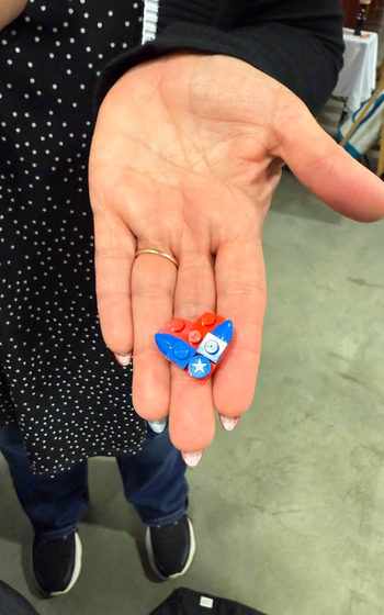 A LEGO piece that looks like the Air Force logo shaped in a heart.
