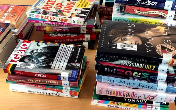 Several stacks of books on a table.