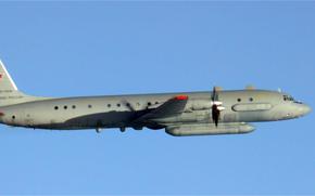 A Russian plane in flight through clear blue sky.