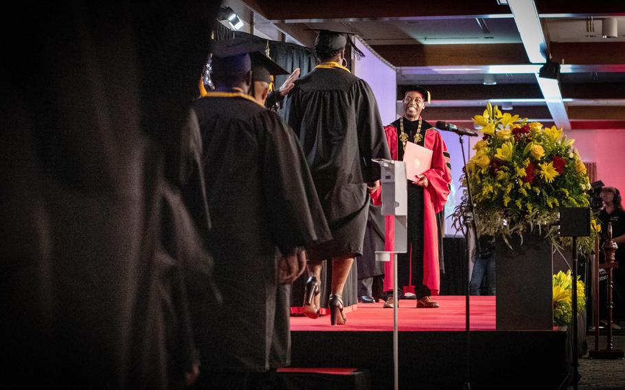 Students graduating from the University of Maryland Global Campus Europe line up to receive their diplomas from Gregory W. Fowler, the university’s president, at a ceremony on Ramstein Air Base, Germany, Saturday, April 29, 2023. 