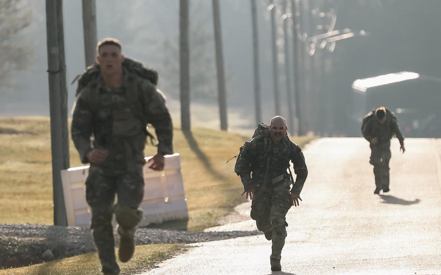 Competitors race toward the finish line of a ruck march during the MSNG Best Warrior Competition at Camp Shelby Joint Forces Training Center, Miss., on March 22, 2023. 