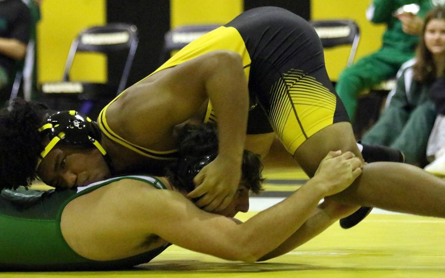 Kadena's Jeremiah Drummer gets control of Kubasaki's Anthony Castle at 180 pounds during Wednesday's Okinawa wrestling dual meet. Drummer pinned Castle in 25 seconds, but Kubasaki won the meet 39-26.