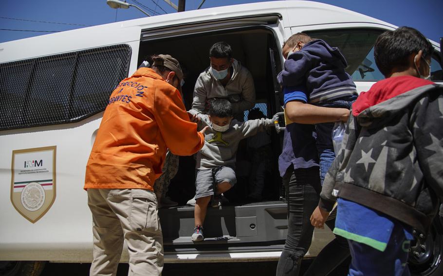 A Mexican government van drops off asylum seekers at Templo Embajadores De Jesus on Thursday, April 8, 2021, in Tijuana, Baja California.