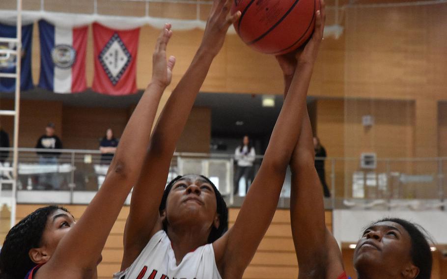 Kaiserslautern’s Hazel Sanders wins the battle for the ball against a pair of Ramstein Royals in a Division I semifinal game at the DODEA European Basketball Championships in Wiesbaden, Germany on Friday, Feb. 16, 2024.