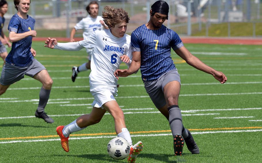 Ansbach’s Nolan Bokor, right, clears the ball in front of Sigonella’s Mikolaj Czernielewski in the Division III boys final at the DODEA-Europe soccer championships in Ramstein, Germany, May 18, 2023. Sigonella won 4-1.