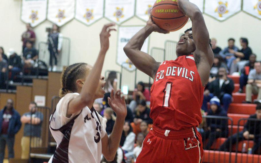 Nile C. Kinnick's Xavier Wright shoots against Matthew C. Perry's Billy Hill during Friday's DODEA-Japan boys basketball game. The Red Devils won 67-29.
