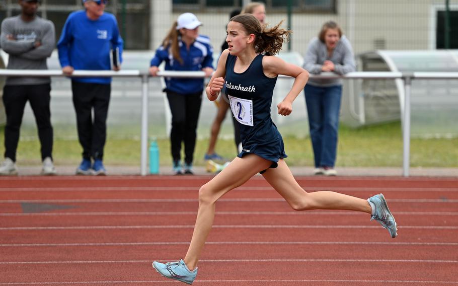 Lakenheath’s Abra Mills rounds the track on the last lap of the girls 3,200-meter race at the DODEA-Europe track and field championships in Kaiserslautern, Germany, May 20, 2023. She took the title, completing the eight laps in 11 minutes, 31.61 seconds.