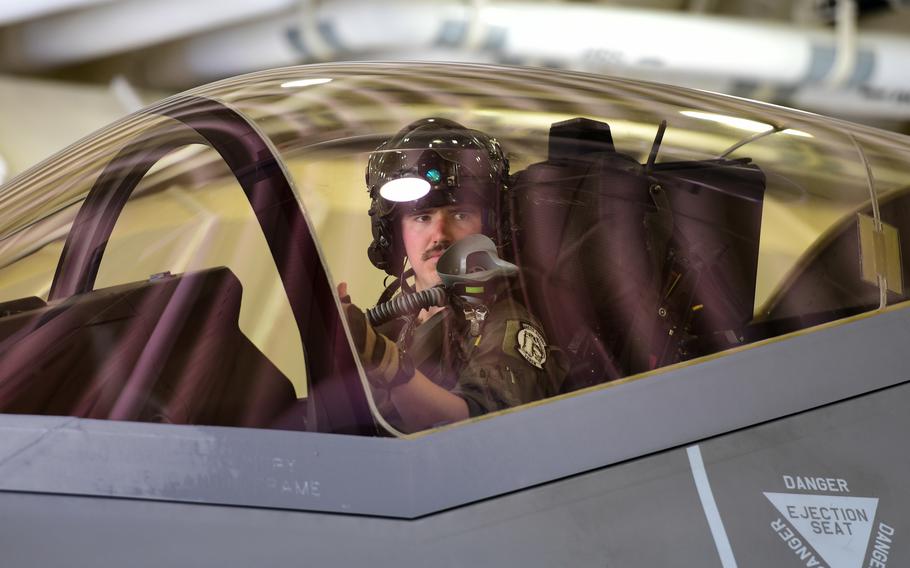 An F-35A Lightning II pilot waits for signals from his ground crew at Kunsan Air Base, South Korea, July 7, 2022. The Air Force grounded hundreds of jets that month while investigating faulty ejection seat components. The jets have since returned to service.