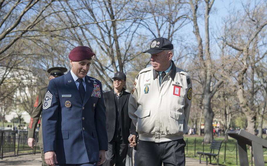 Retired Army Lt. Col. Hank Cramer talks with Senior Enlisted Advisor to the Chairman of the Joint Chiefs of Staff Ramon Colon-Lozez as they make their way to the Vietnam Veterans Memorial wall on Wednesday, March 29, 2023, in Washington, D.C., where a silent wreath laying ceremony was held in honor of National Vietnam War Veterans Day.
