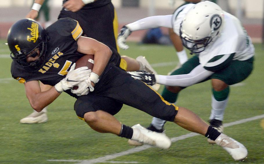 Kadena running back Trent Fowler leans for a couple of extra yards against Kubasaki.