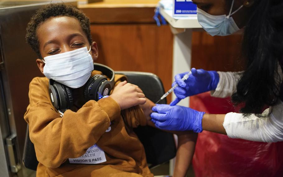 Cameron West, 9, receives a COVID-19 vaccination at Englewood Health in Englewood, N.J., Monday, Nov. 8, 2021. Health systems have released little data on the racial breakdown of youth vaccinations, and community leaders fear that Black and Latino kids are falling behind.